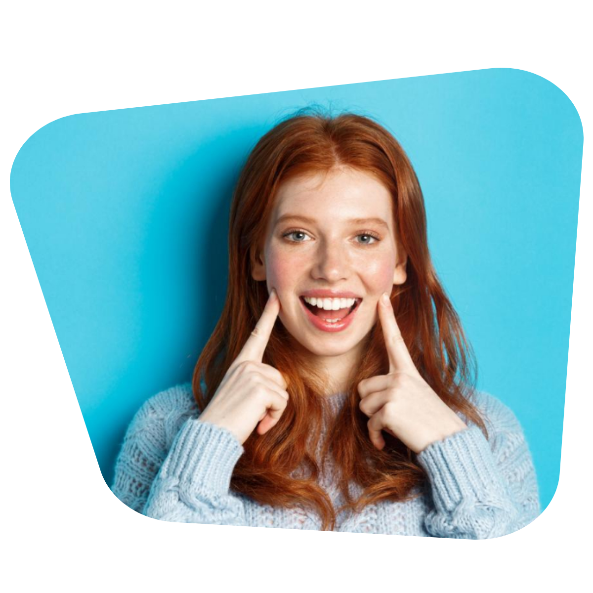 Closeup of cheerful teenage girl with red hair and freckles poking cheeks showing dimples and smiling